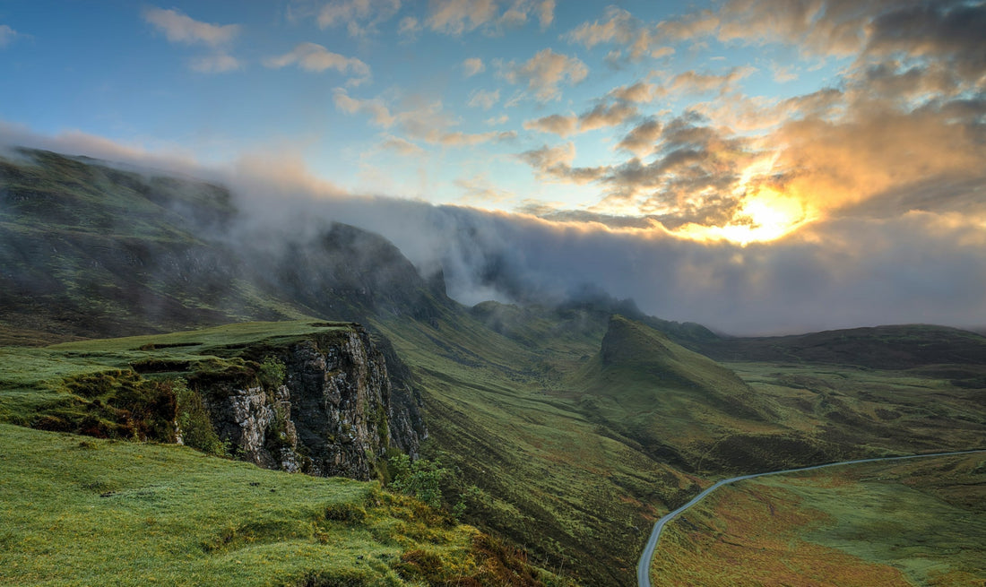 Sun shining over a mountain and green valley