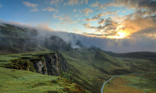 Sun shining over a mountain and green valley